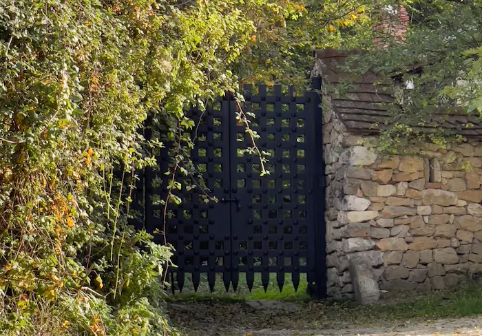 Entrance gate with autumn foliage and stone walls