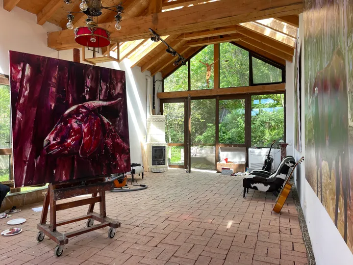 Artist studio with large bull painting and wooden beams